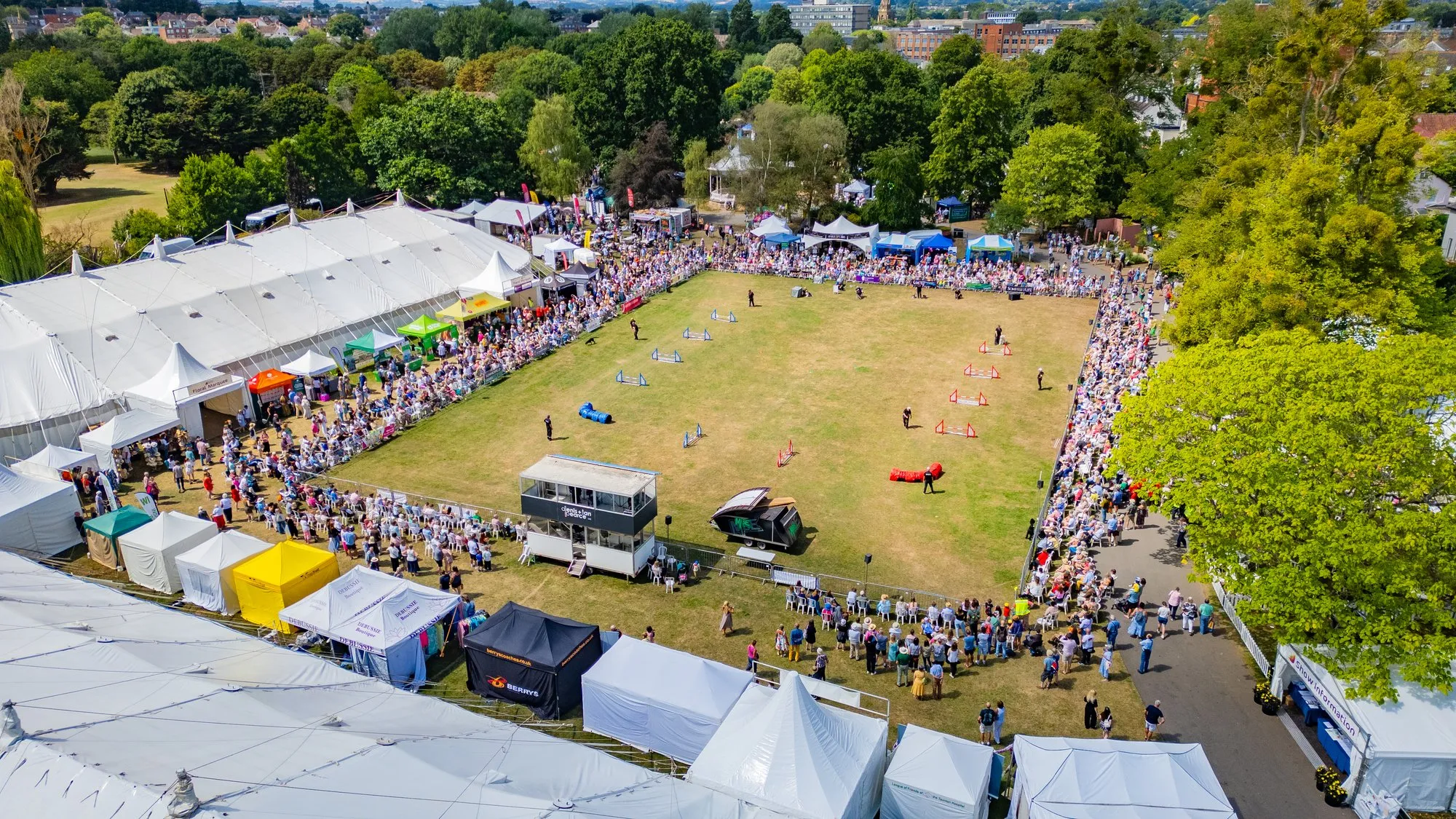 Aerial view of crowds gathered around the main arena at Taunton Flower Show